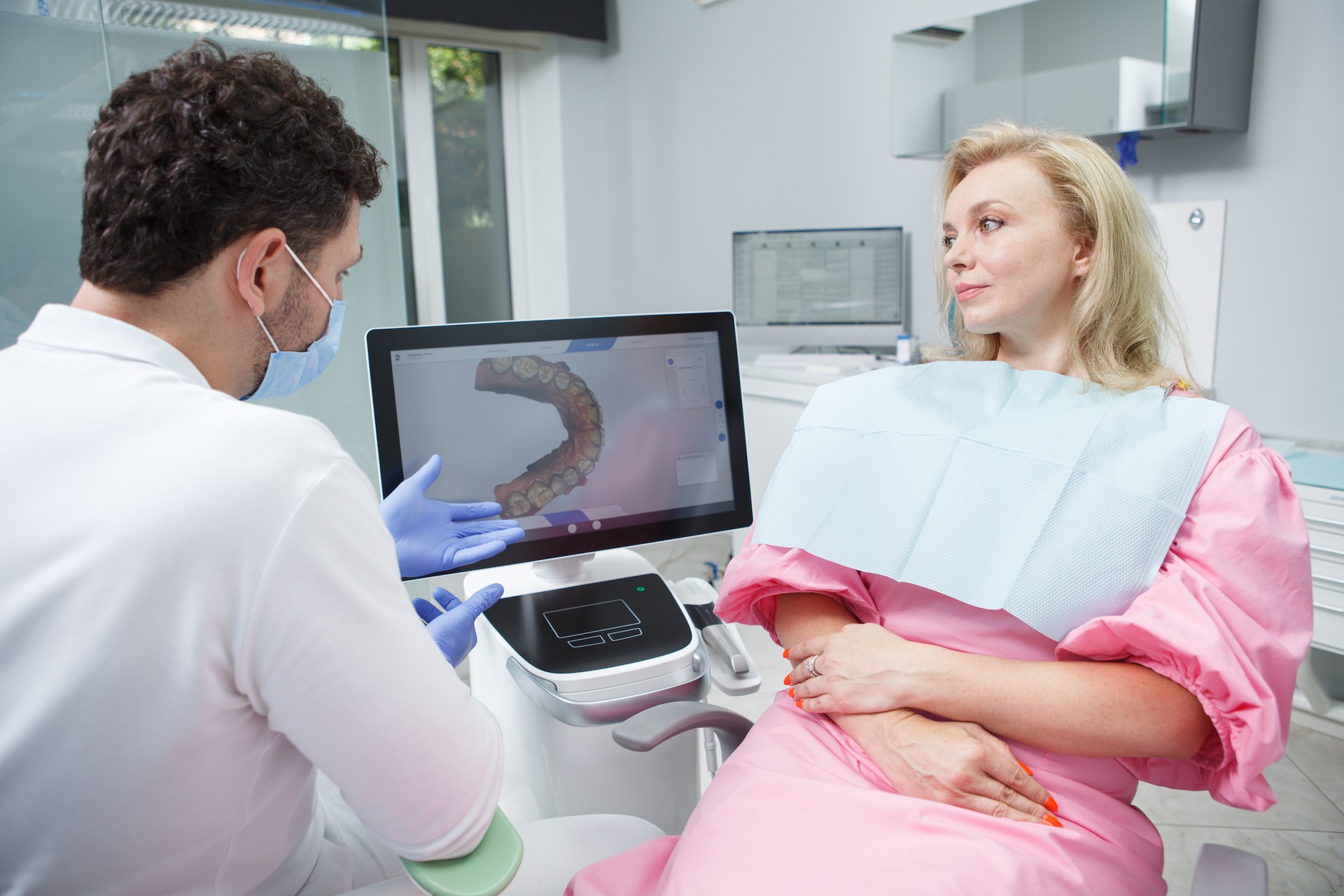 Mature woman discussing her dental scan with her dentist